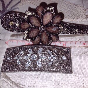 Two lovely flower design hair clips with intricate designs.